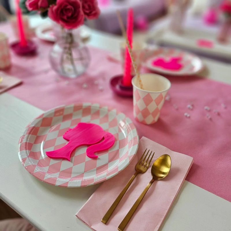 Roze feesttafel met bloemen en gouden bestek